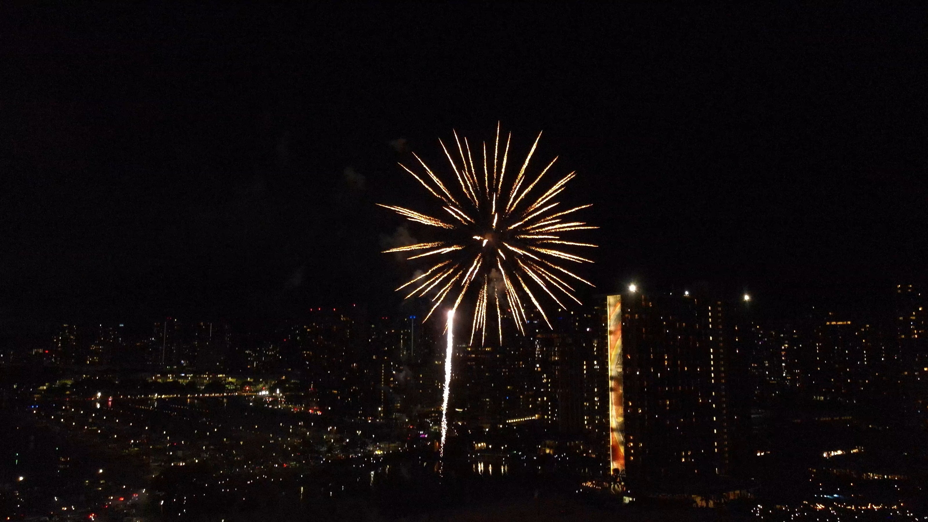 Fireworks exploding by the hilton hawaiian hotel in hawaii waikiki.